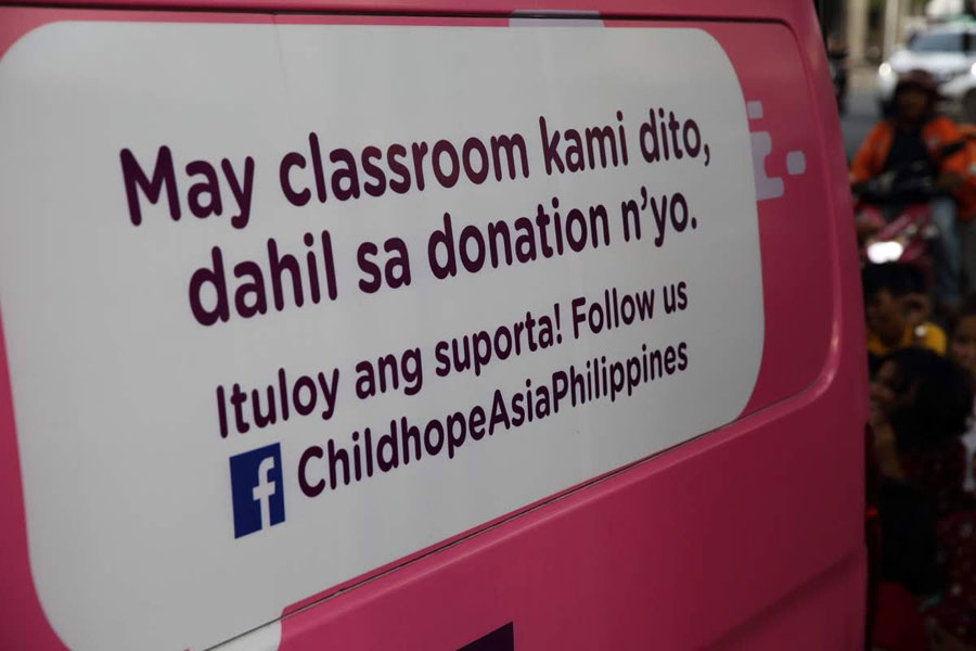 Childhope Philippines' cause written on the side of the mobile van - street children photos