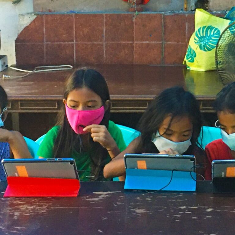 children using tablets for their online learning