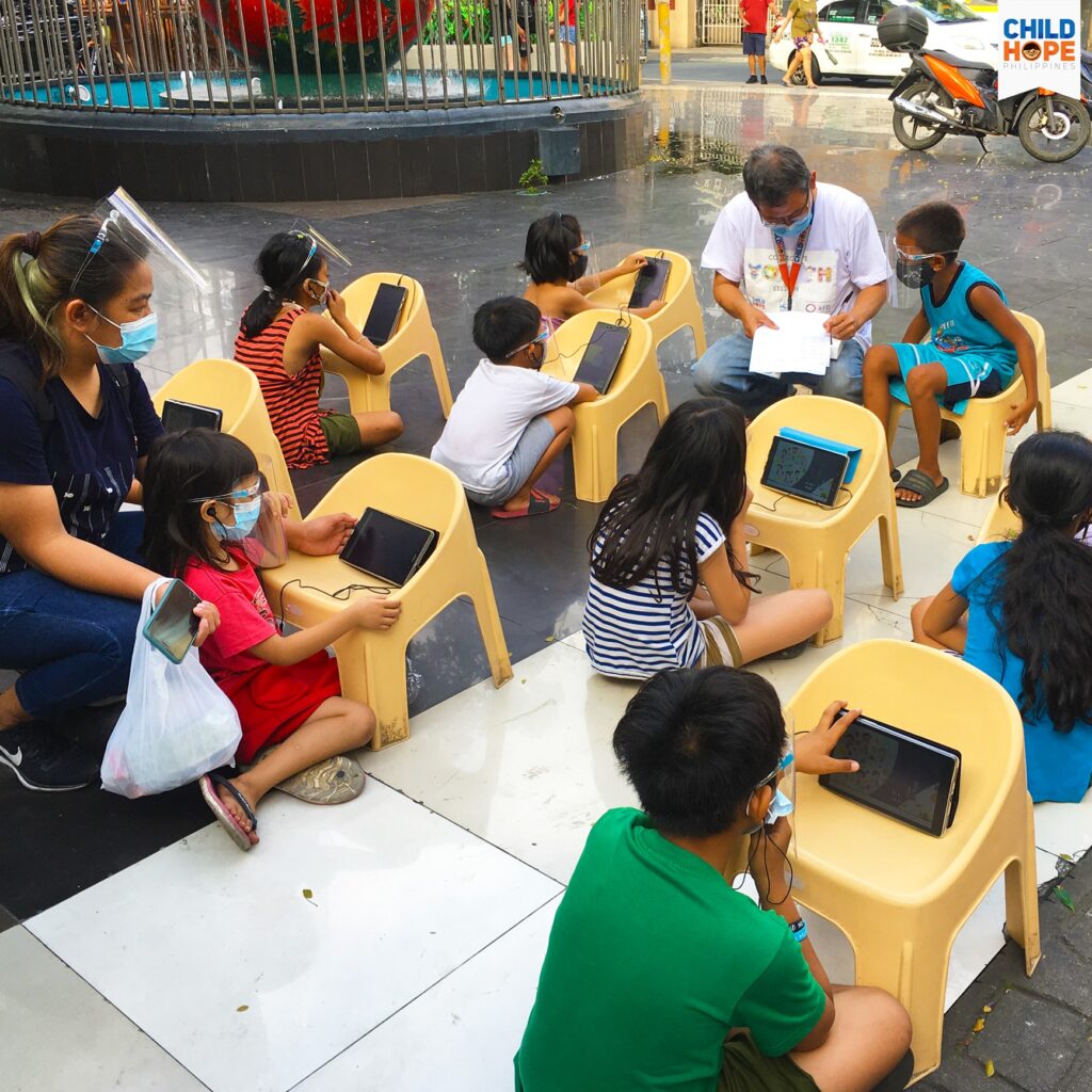 street children using tablets for learning