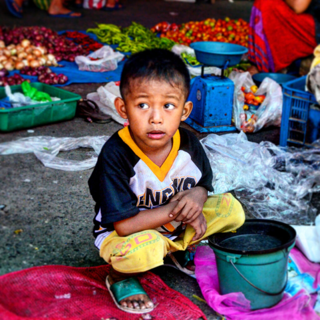 a picture of a young child already working in the market