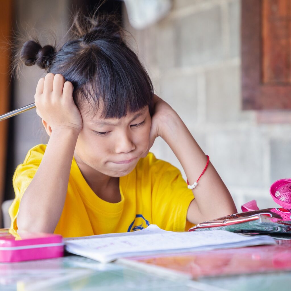 little girl doing her homework at home