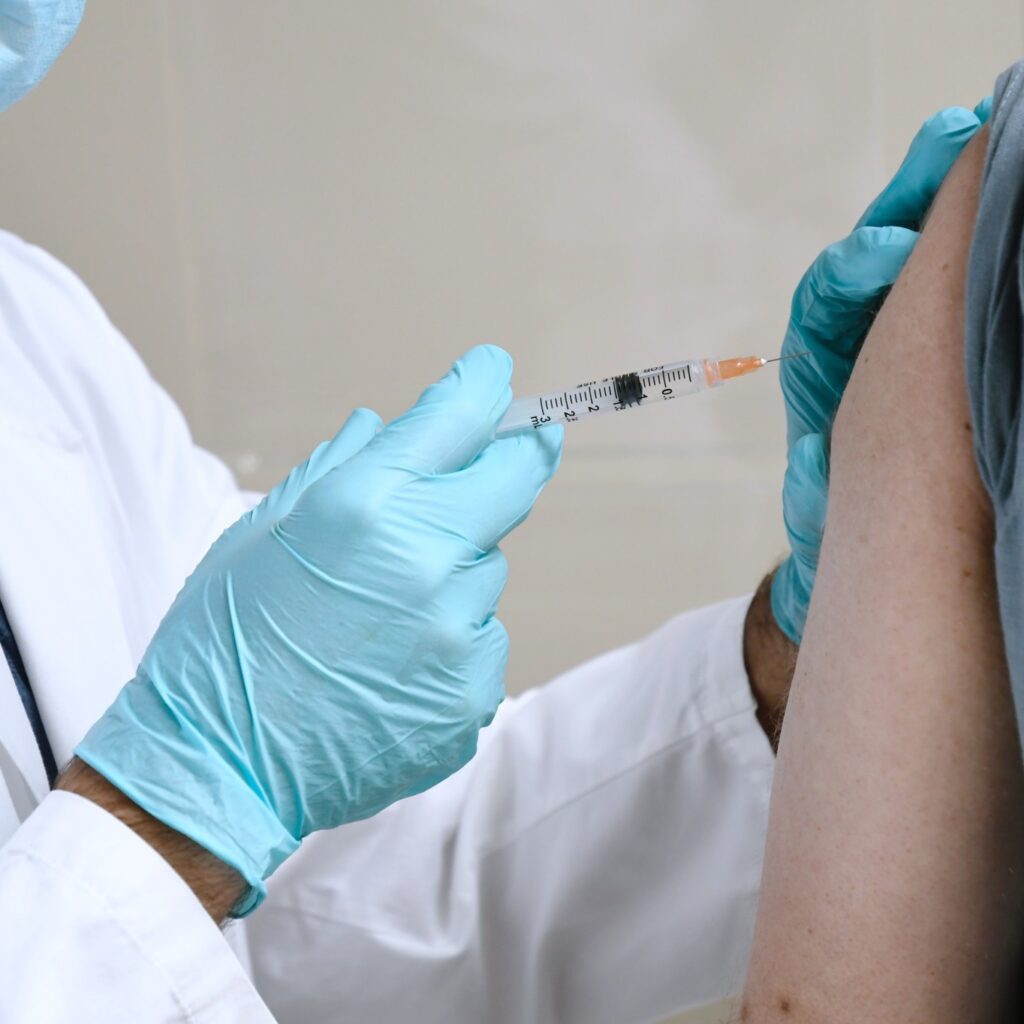 doctor holding a syringe to vaccinate