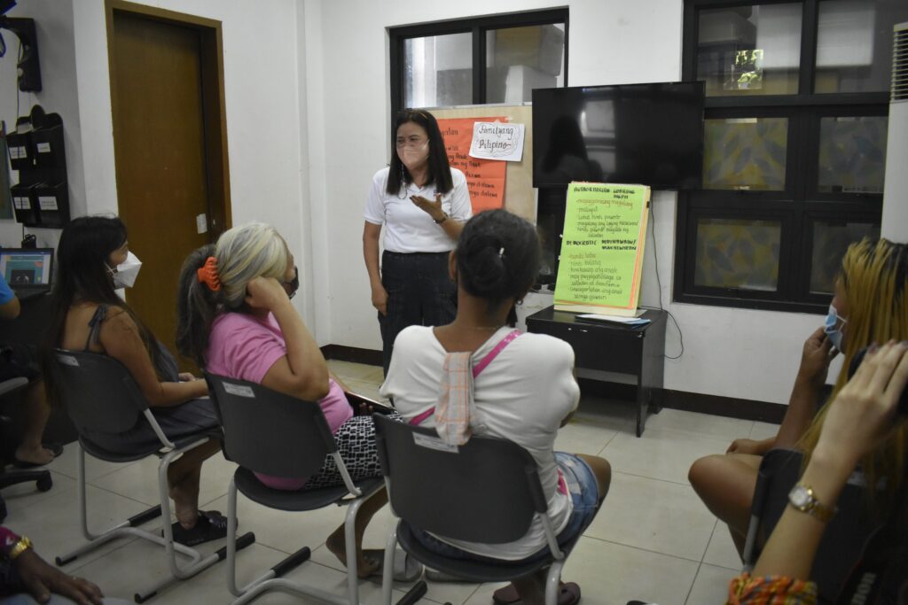 Childhope volunteer conducting a program regarding mental health awareness for parents.