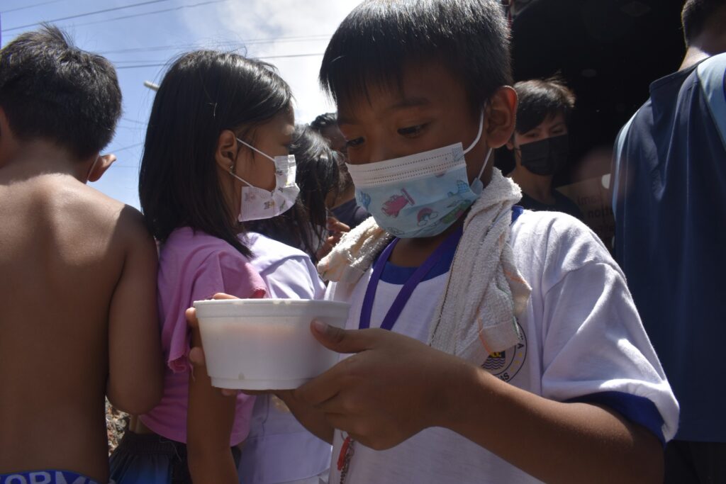 a boy enjoys a meal during World Food Day