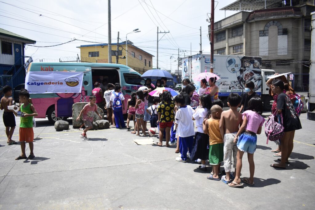 children lining up during Childhope's Kalyenderia soup kitchen