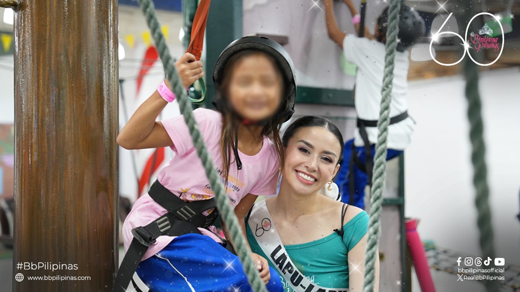 child beneficiary and binibining pilipinas candidate smiling together