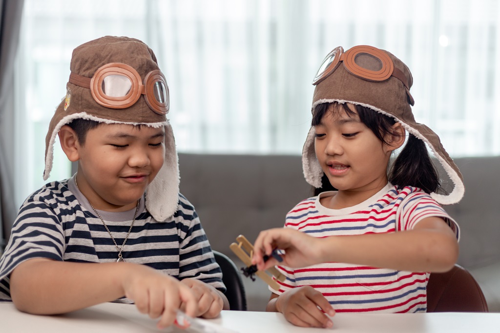 two children imagining themselves as pilots