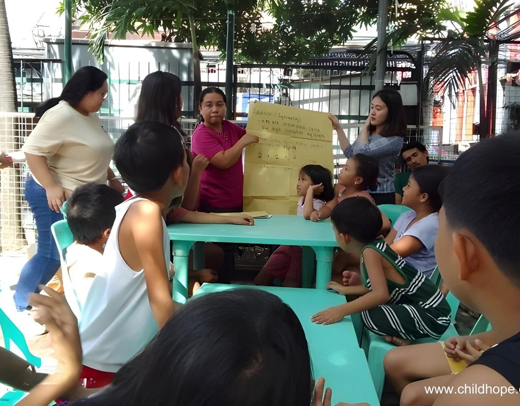 Childhope staff teaching street children to promote early childhood education