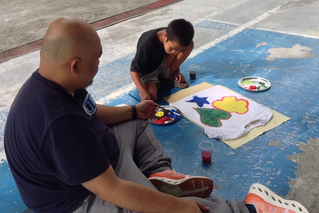 volunteer helping a child beneficiary during activities