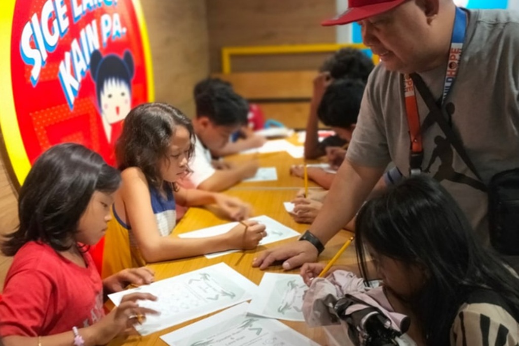 Childhope staff assisting children with basic math exercises