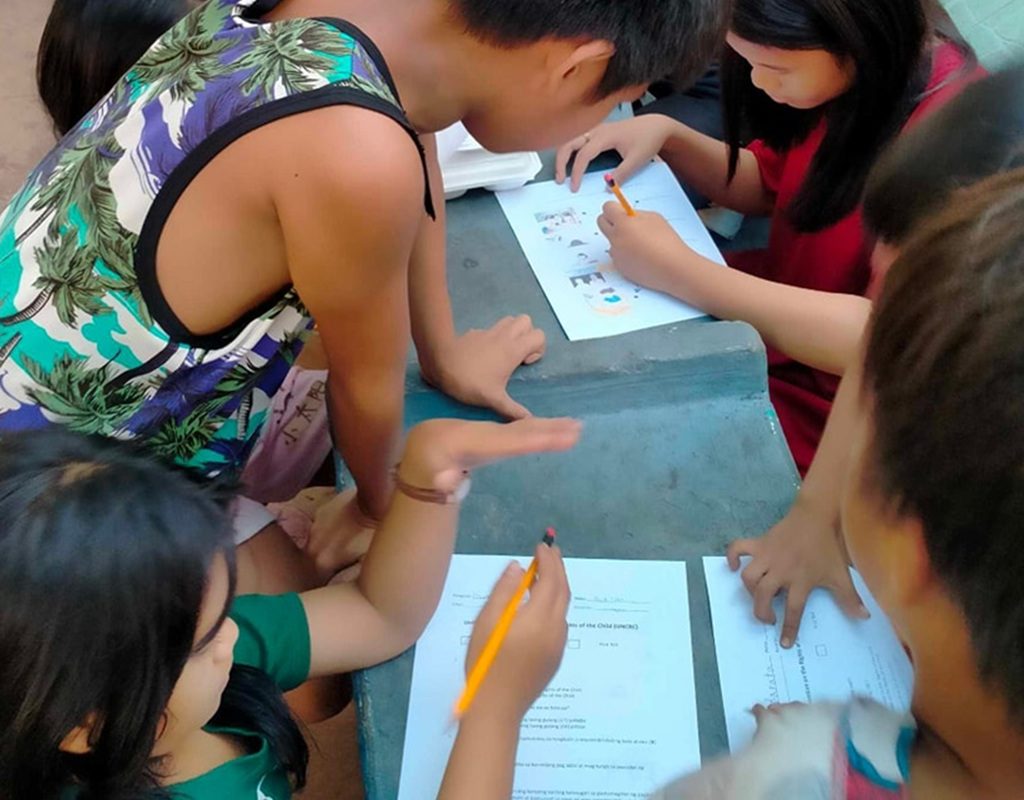 street children studying with educational handouts