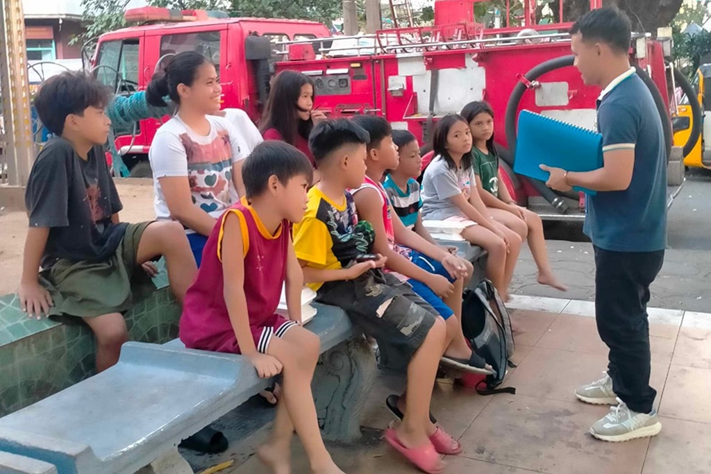 volunteer teaching children about the importance of literacy and numeracy skills