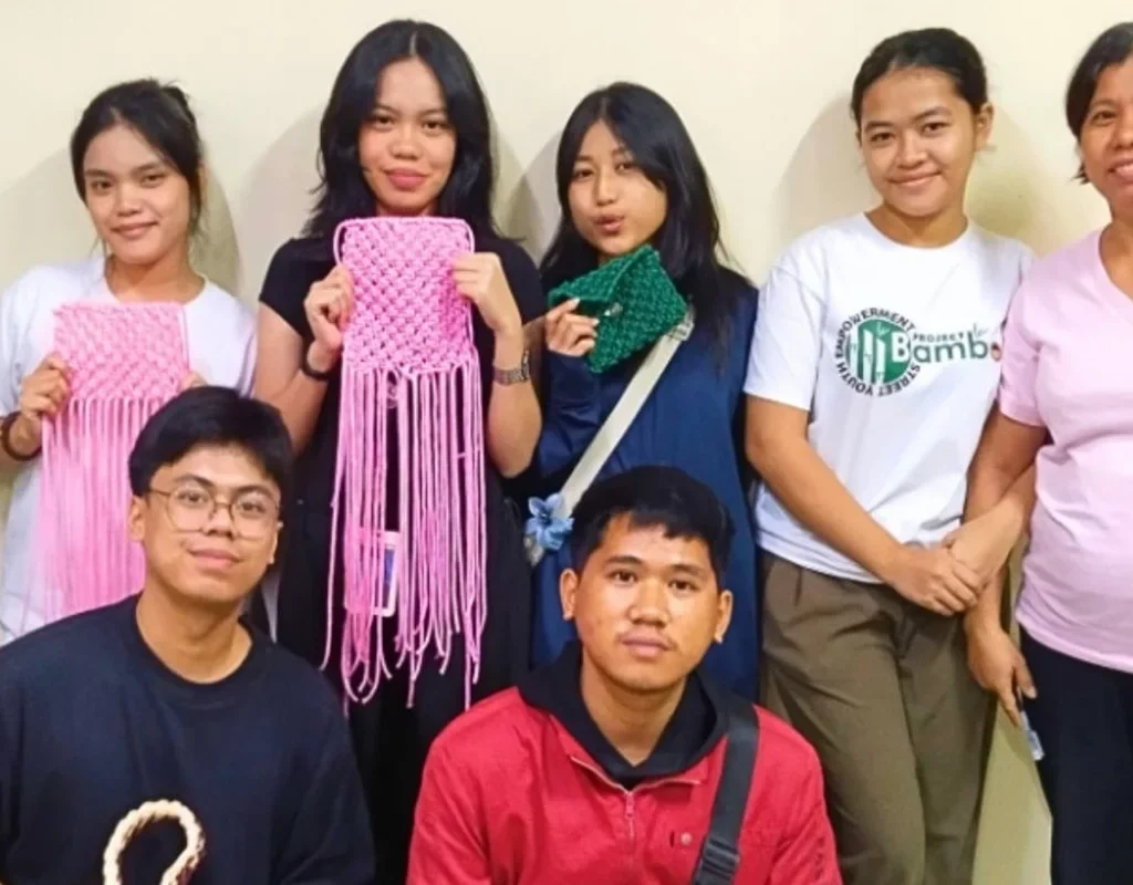 interns showcasing the finish product of the macrame workshop