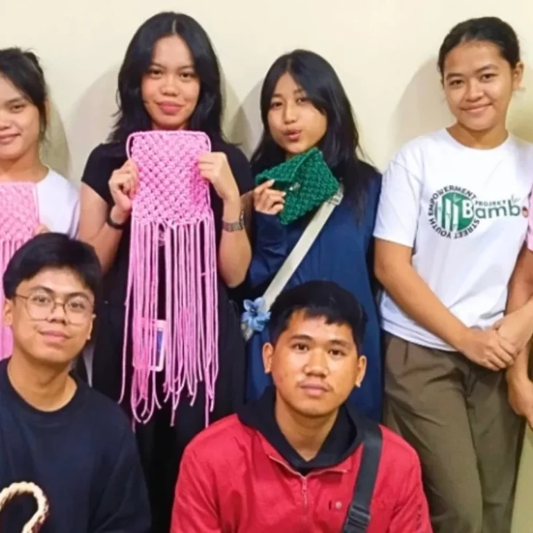interns showcasing the finish product of the macrame workshop